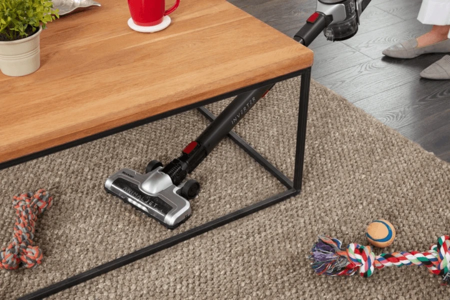 Odkurzanie odkurzaczem pionowym Sharp pod stołem